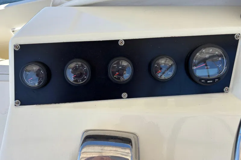 Slide: The Image of Instrument panel of a 1985 Egg Harbor 37 Tournament boat, featuring various gauges. - 10