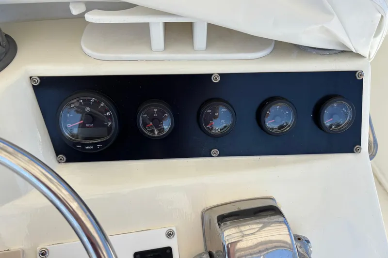 Slide: The Image of Dashboard gauges of a 1985 Egg Harbor 37 Tournament boat. - 11