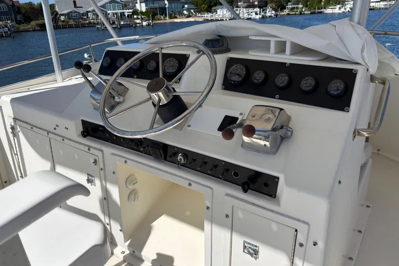 Slide: The Image of 1985 Egg Harbor 37 Tournament boat helm with steering wheel and control panel. - 12