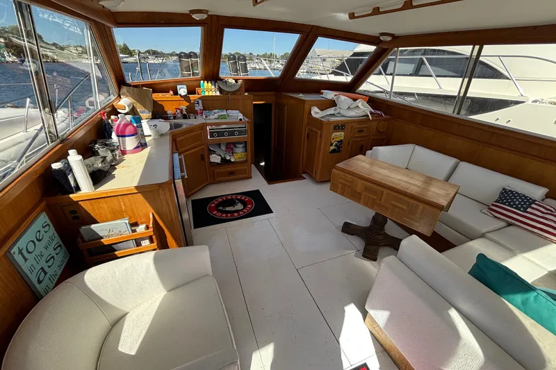 Slide: The Image of Interior of 1985 Egg Harbor 37 Tournament yacht with cozy seating and wooden accents. - 16