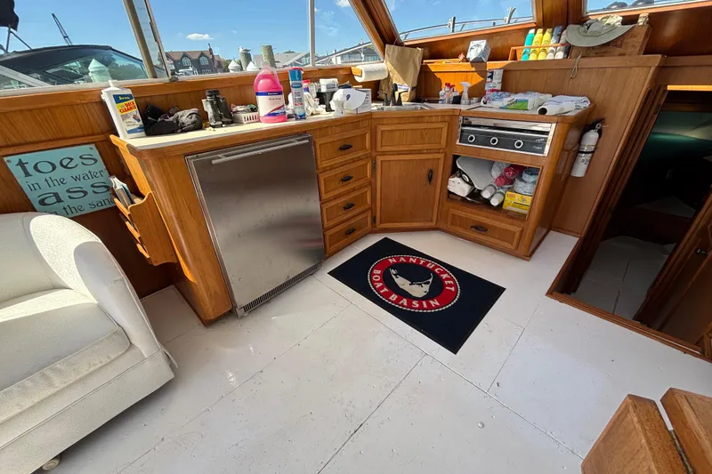 Slide: The Image of Interior of 1985 Egg Harbor 37 Tournament boat with kitchenette and Nantucket Boat Basin mat. - 18