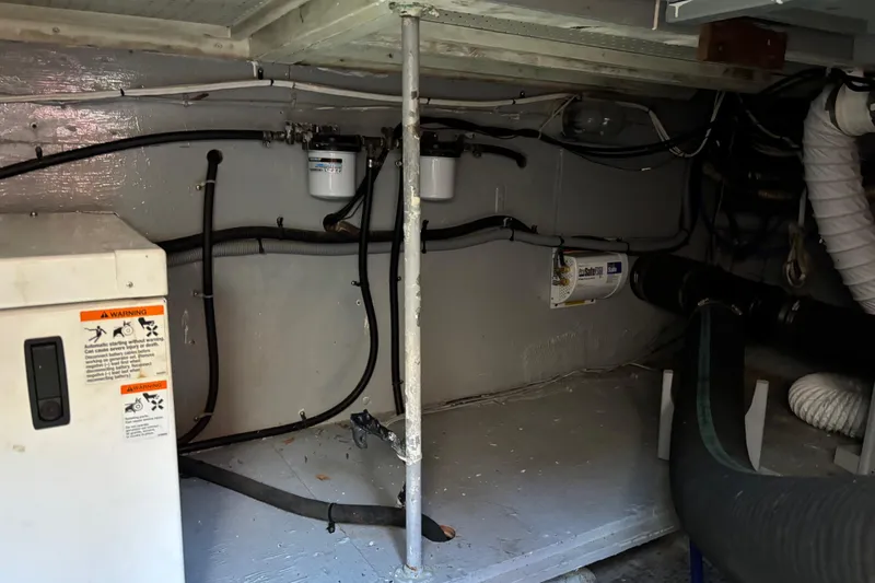 Slide: The Image of Engine room of 1985 Egg Harbor 37 Tournament boat, showing wiring and equipment. - 20