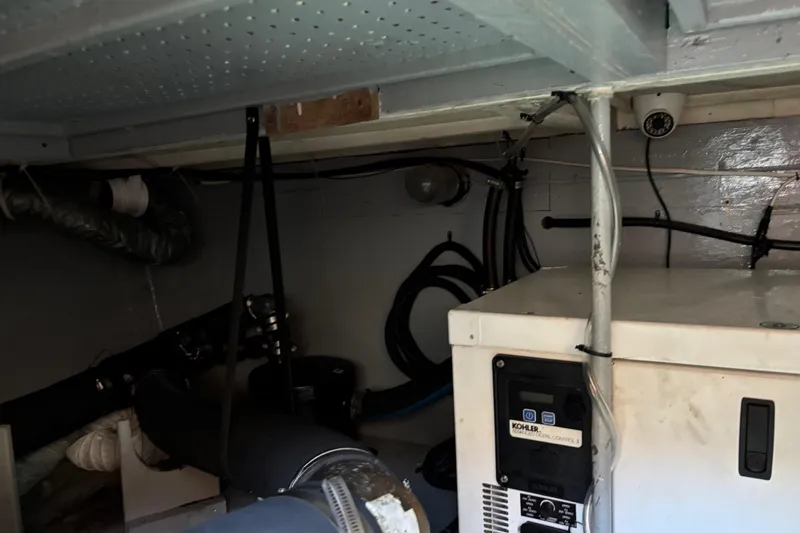 Slide: The Image of Engine room of 1985 Egg Harbor 37 Tournament boat with Kohler generator and wiring. - 21