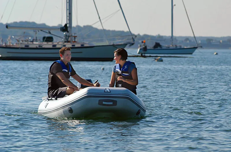 Slide: The Image of Two people enjoying a ride on a 2024 Achilles HB-280LX inflatable boat. - 3