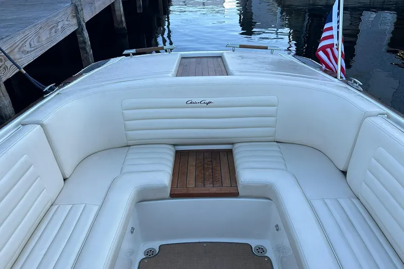 Slide: The Image of 2013 Chris-Craft Corsair 25 boat with elegant white seating and wooden accents. - 17