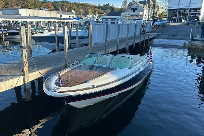 Slide: The Image of 2013 Chris-Craft Corsair 25 docked at marina, calm water, sunny day. - 3