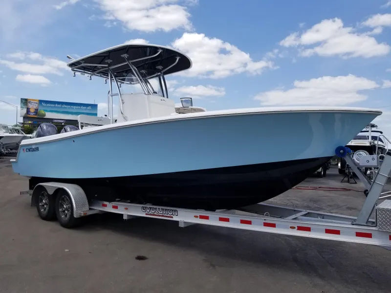 Slide: The Image of 2024 Contender 25 Tournament boat on a trailer under a blue sky. - 2