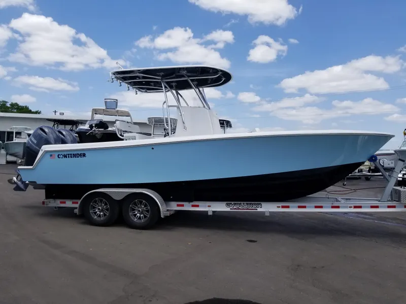 Slide: The Image of 2024 Contender 25 Tournament boat on trailer under blue sky. - 3