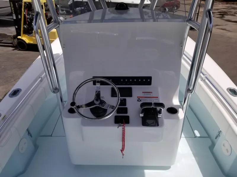Slide: The Image of 2024 Contender 25 Tournament boat console with steering wheel and controls. - 8