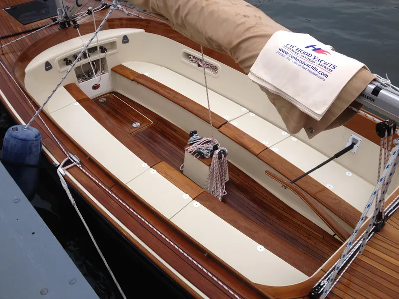 Slide: The Image of 2026 C.W. Hood 32 Daysailer with wooden deck and beige sail cover. - 1