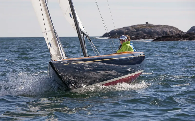 Slide: The Image of 2026 C.W. Hood 32 Daysailer navigating ocean waters near rocky island. - 4