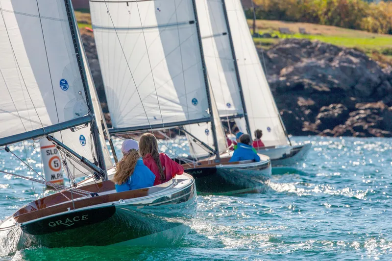 Slide: The Image of Sailboats racing near rocky shore, featuring 2026 C.W. Hood 32 Daysailer. - 6