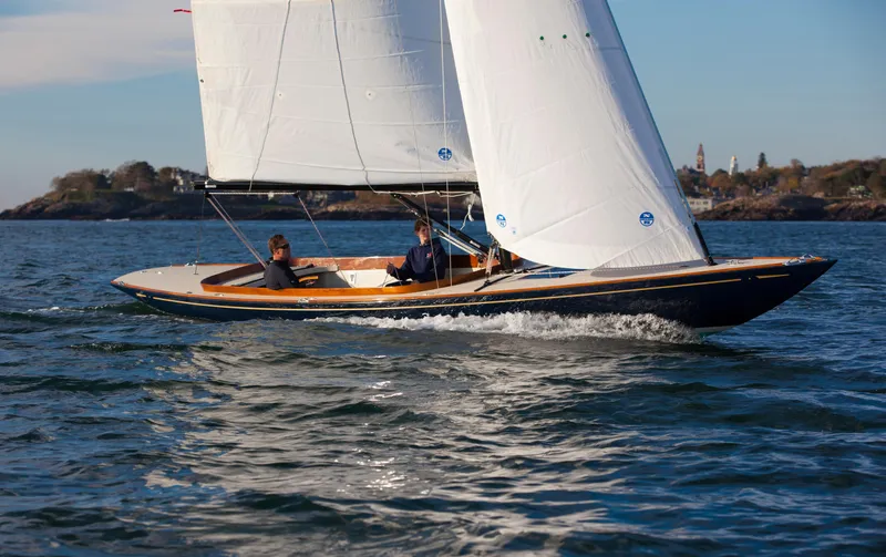 The Image of 2026 C.W. Hood 32 Daysailer gliding on open water, showcasing sleek design and white sails. - 0