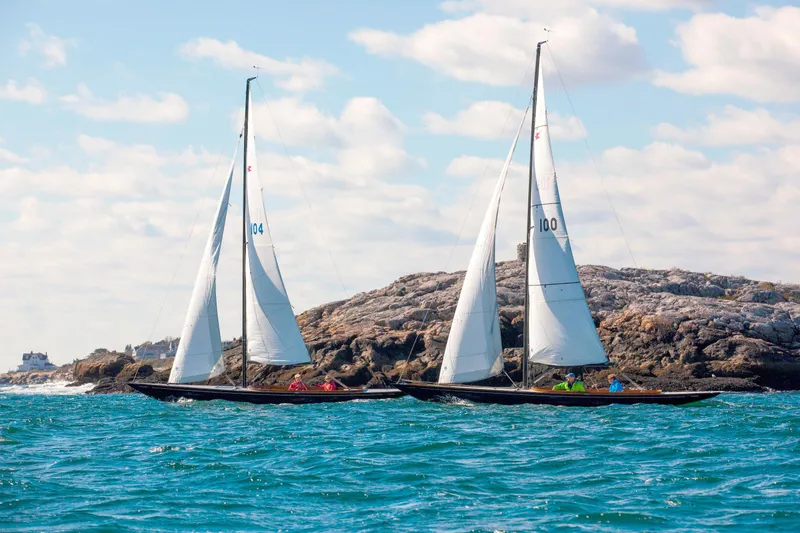 Slide: The Image of Two C.W. Hood 32 Daysailers sailing near rocky coastline under blue sky. - 7
