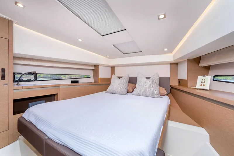 Slide: The Image of Prestige 460 Flybridge 2025 yacht interior bedroom with modern design and comfortable bedding. - 10