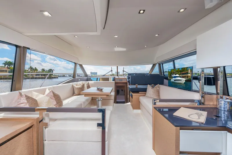 Slide: The Image of Luxurious interior of the 2025 Prestige 460 Flybridge yacht with panoramic windows. - 15