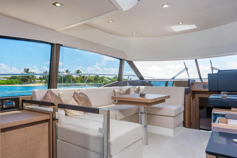 Slide: The Image of Luxurious interior of the 2025 Prestige 460 Flybridge yacht with scenic ocean view. - 16