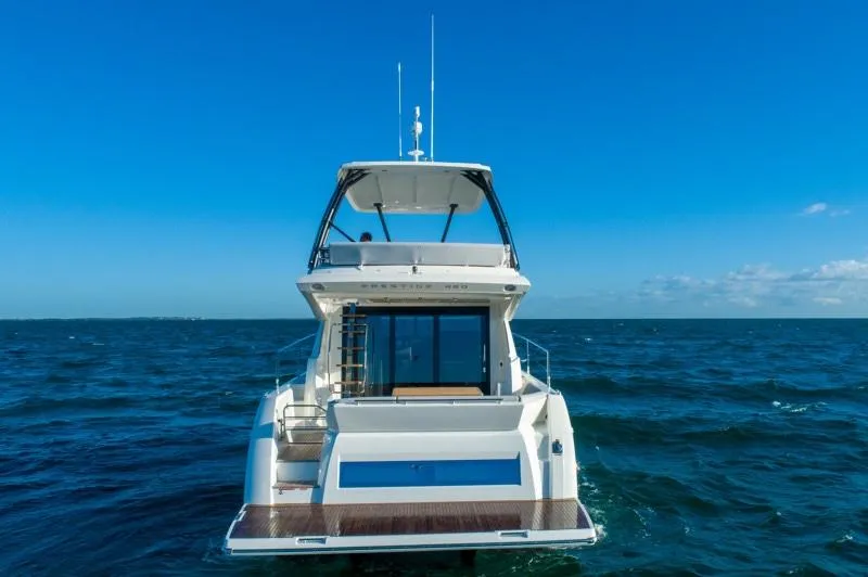 Slide: The Image of 2025 Prestige 460 Flybridge yacht on open sea. - 2