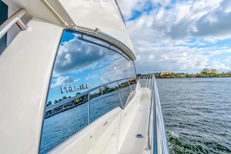 Slide: The Image of 2025 Prestige 460 Flybridge yacht cruising on a sunny day. - 21