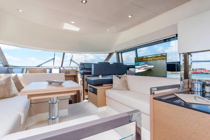 Slide: The Image of Luxurious interior of the 2025 Prestige 460 Flybridge yacht with modern furnishings and panoramic windows. - 23