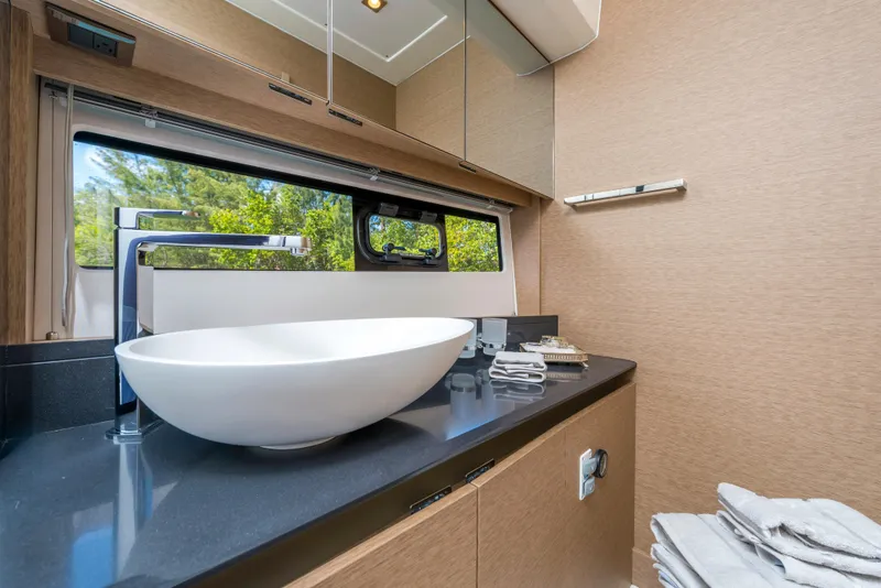 Slide: The Image of Modern bathroom in 2025 Prestige 460 Flybridge yacht with vessel sink and sleek design. - 25