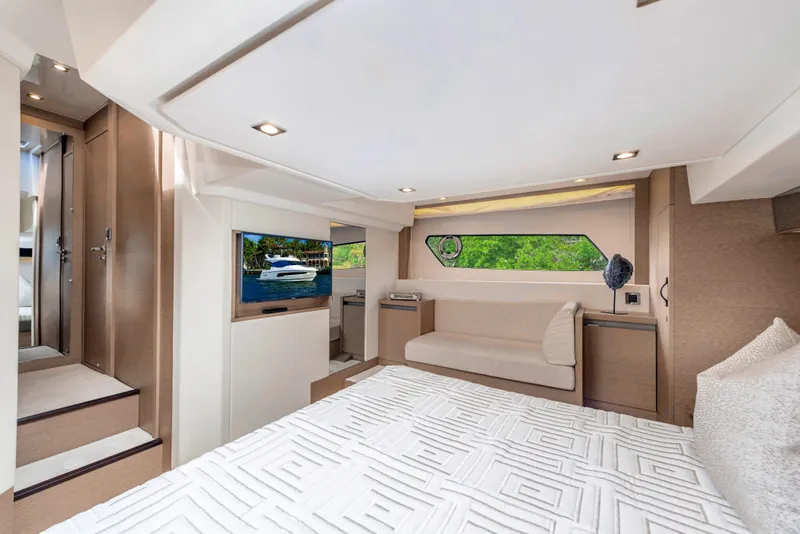 Slide: The Image of Luxurious bedroom interior of 2025 Prestige 460 Flybridge yacht with modern decor and scenic window view. - 26