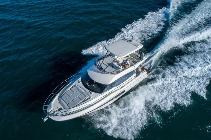 Slide: The Image of Aerial view of 2025 Prestige 460 Flybridge yacht cruising on open water. - 4