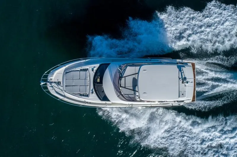 Slide: The Image of Aerial view of 2025 Prestige 460 Flybridge yacht cruising on water. - 5