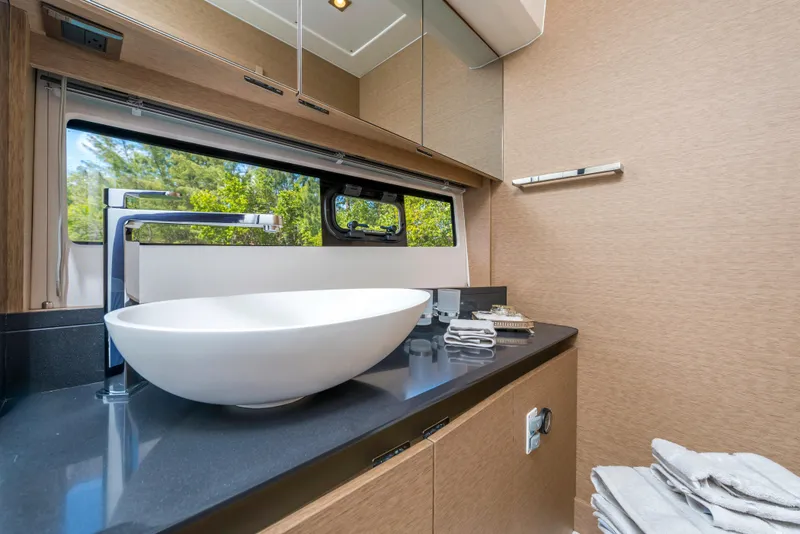 Slide: The Image of Modern bathroom in 2025 Prestige 460 Flybridge yacht with sleek sink and large mirror. - 8