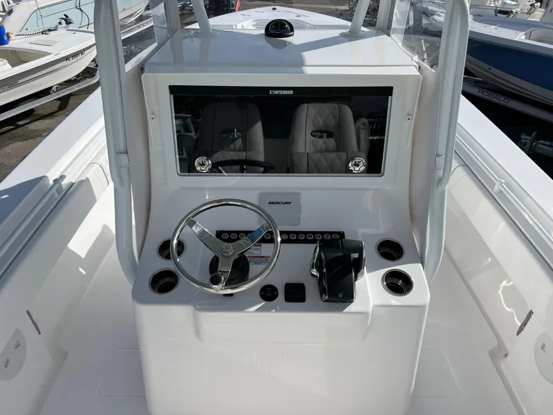 Slide: The Image of 2024 Contender 32 ST boat console with steering wheel and controls. - 10