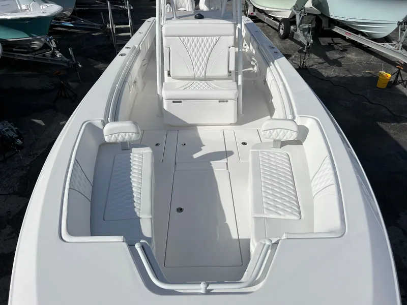 Slide: The Image of 2024 Contender 32 ST boat interior with white cushioned seating and center console. - 12
