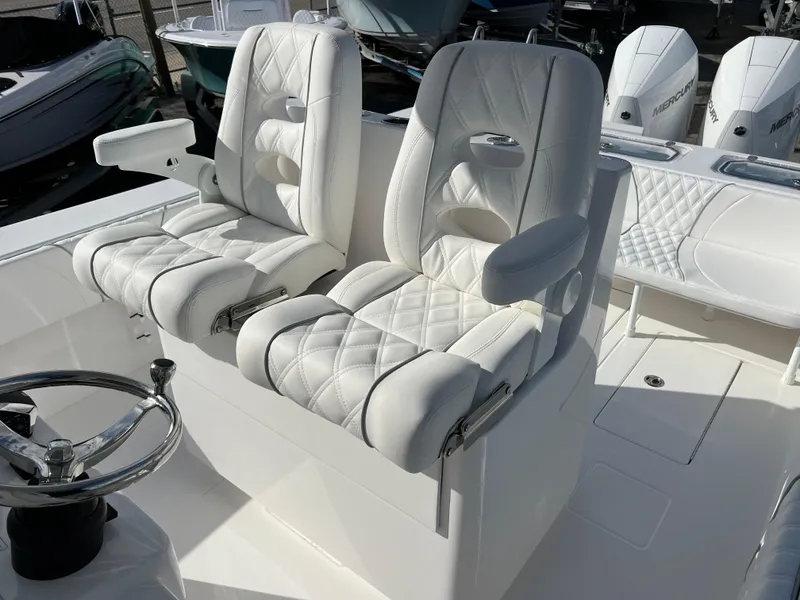 Slide: The Image of 2024 Contender 32 ST boat with luxurious white leather seats and dual outboard engines. - 13