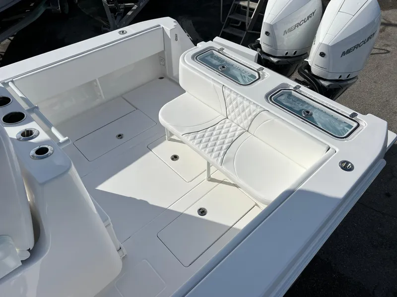 Slide: The Image of 2024 Contender 32 ST boat interior with white seating and twin Mercury engines. - 14