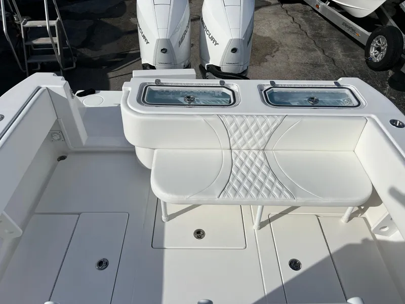 Slide: The Image of 2024 Contender 32 ST boat with dual Mercury engines and white cushioned seating. - 15