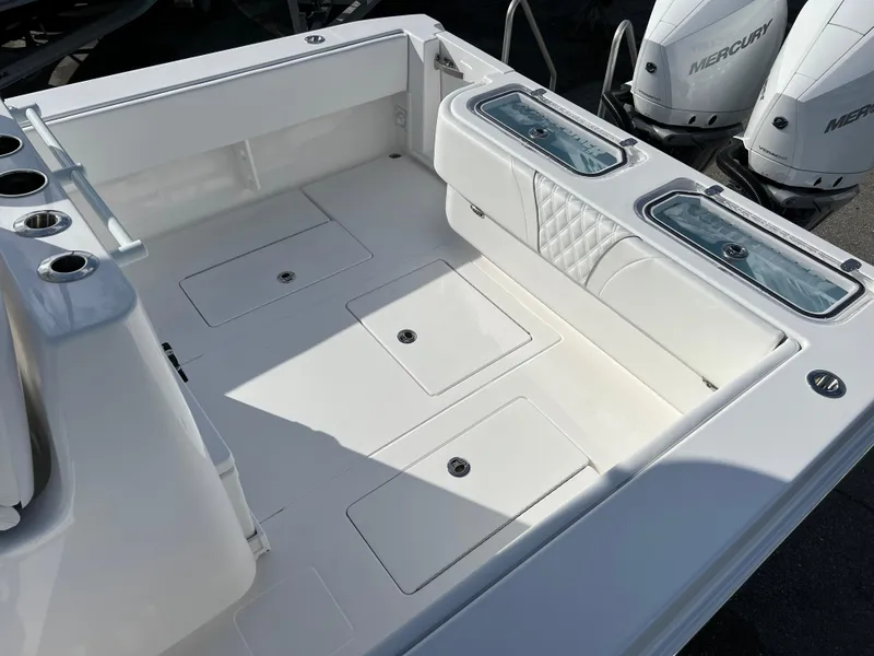 Slide: The Image of 2024 Contender 32 ST boat deck with storage compartments and twin Mercury engines. - 16