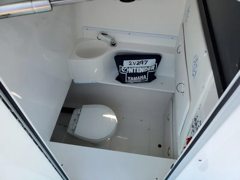 Slide: The Image of 2024 Contender 32 ST boat interior bathroom with toilet and sink. - 18