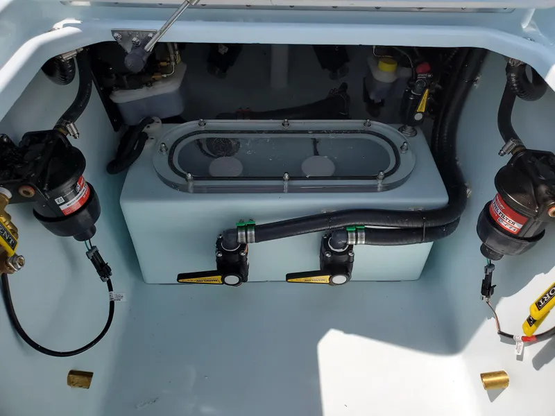 Slide: The Image of 2024 Contender 32 ST boat engine compartment with fuel filters and wiring. - 19