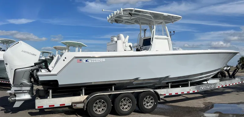 Slide: The Image of 2024 Contender 32 ST boat on a trailer with triple-axle wheels. - 3