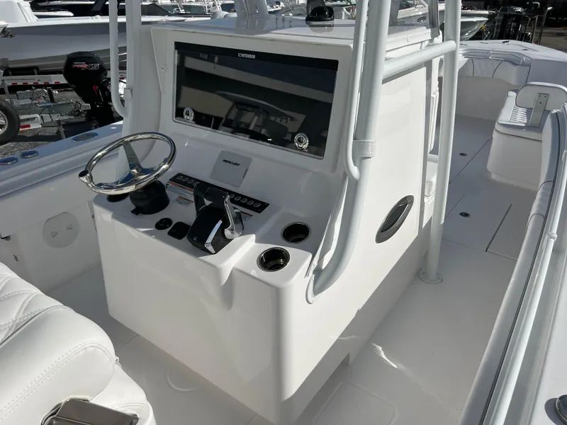 Slide: The Image of 2024 Contender 32 ST boat console with steering wheel and controls. - 9