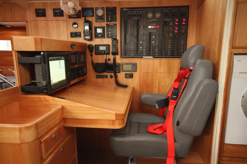 Slide: The Image of Navigation station of 2026 Lyman Morse Farr Racer-Cruiser, featuring advanced control panels and seating. - 13