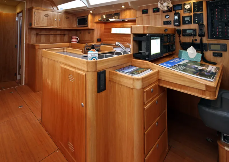 Slide: The Image of Luxurious Lyman Morse Farr Racer-Cruiser 2026 interior with wooden cabinetry and navigation equipment. - 14