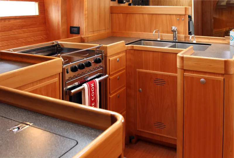 Slide: The Image of Luxurious wooden yacht kitchen interior in 2026 Lyman Morse Farr Racer-Cruiser. - 17
