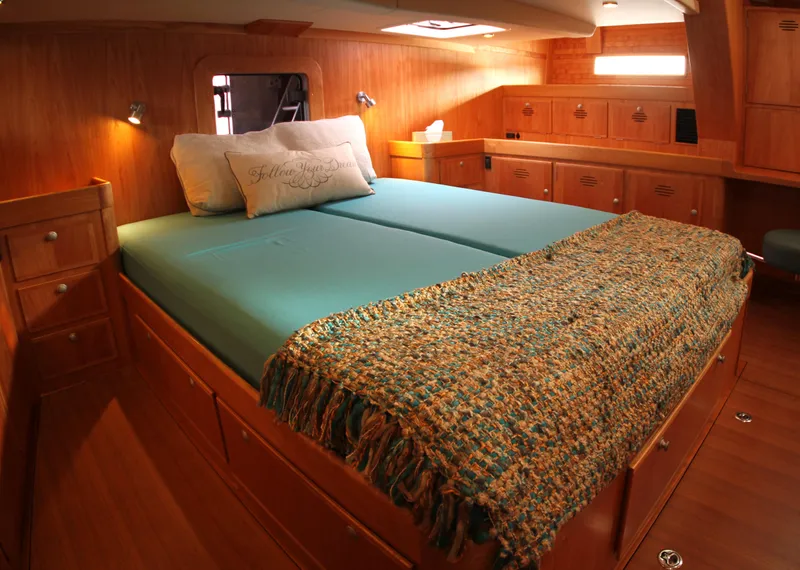 Slide: The Image of Luxurious cabin interior of 2026 Lyman Morse Farr Racer-Cruiser, featuring a cozy bed and wooden finish. - 4