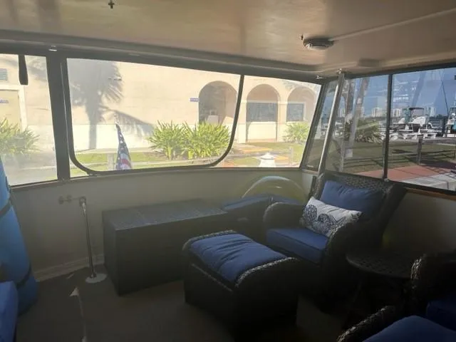 Slide: The Image of Interior of 1989 Californian 48 Motor Yacht with comfortable seating and large windows. - 10