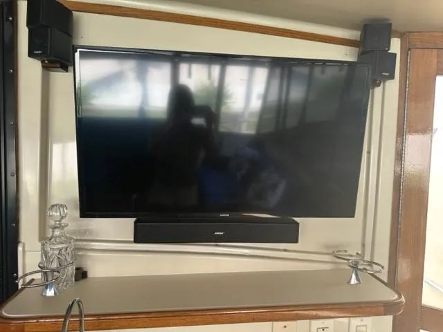 Slide: The Image of Flat-screen TV and soundbar setup on 1989 Californian 48 Motor Yacht interior. - 12