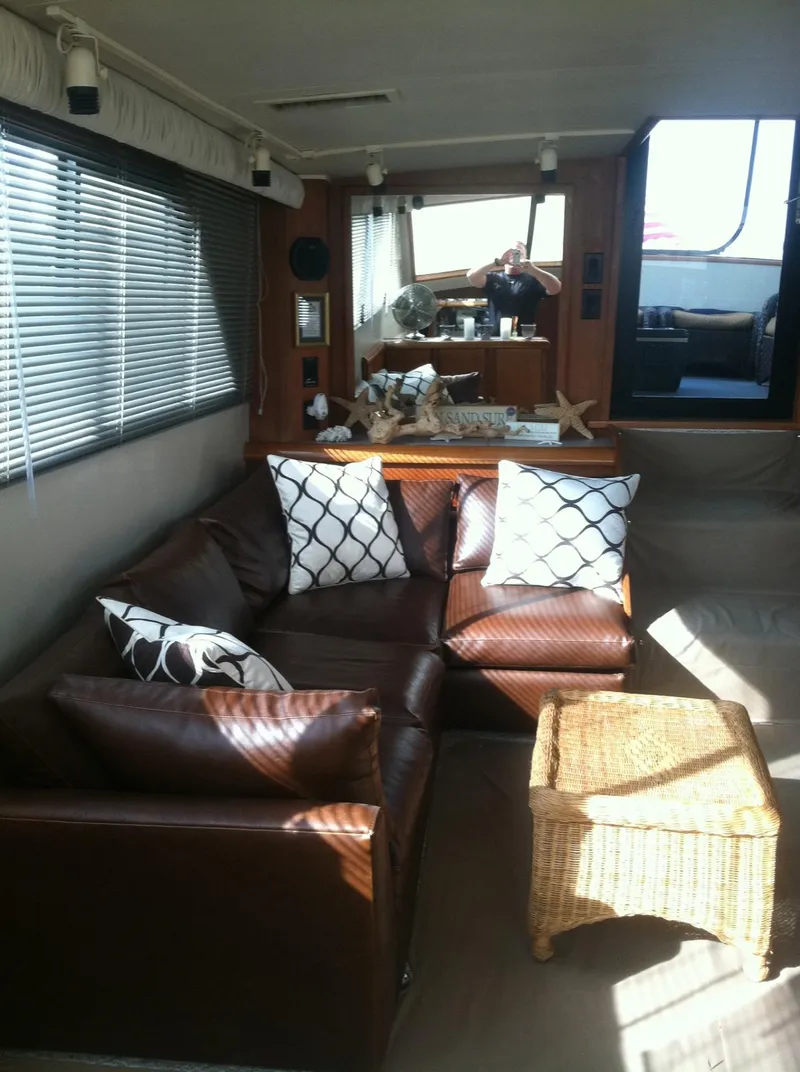 Slide: The Image of Interior of 1989 Californian 48 Motor Yacht with leather seating and wicker table. - 13
