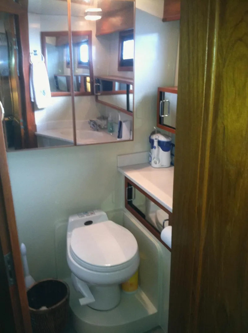 Slide: The Image of Bathroom interior of 1989 Californian 48 Motor Yacht with mirror and toilet. - 16