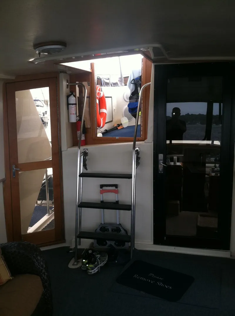 Slide: The Image of Interior view of 1989 Californian 48 Motor Yacht with open hatch and safety equipment. - 19
