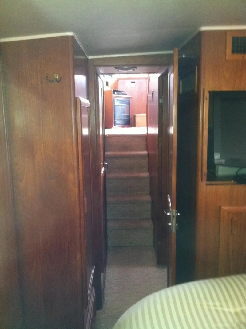 Slide: The Image of Interior hallway of 1989 Californian 48 Motor Yacht with wooden paneling and stairs. - 23