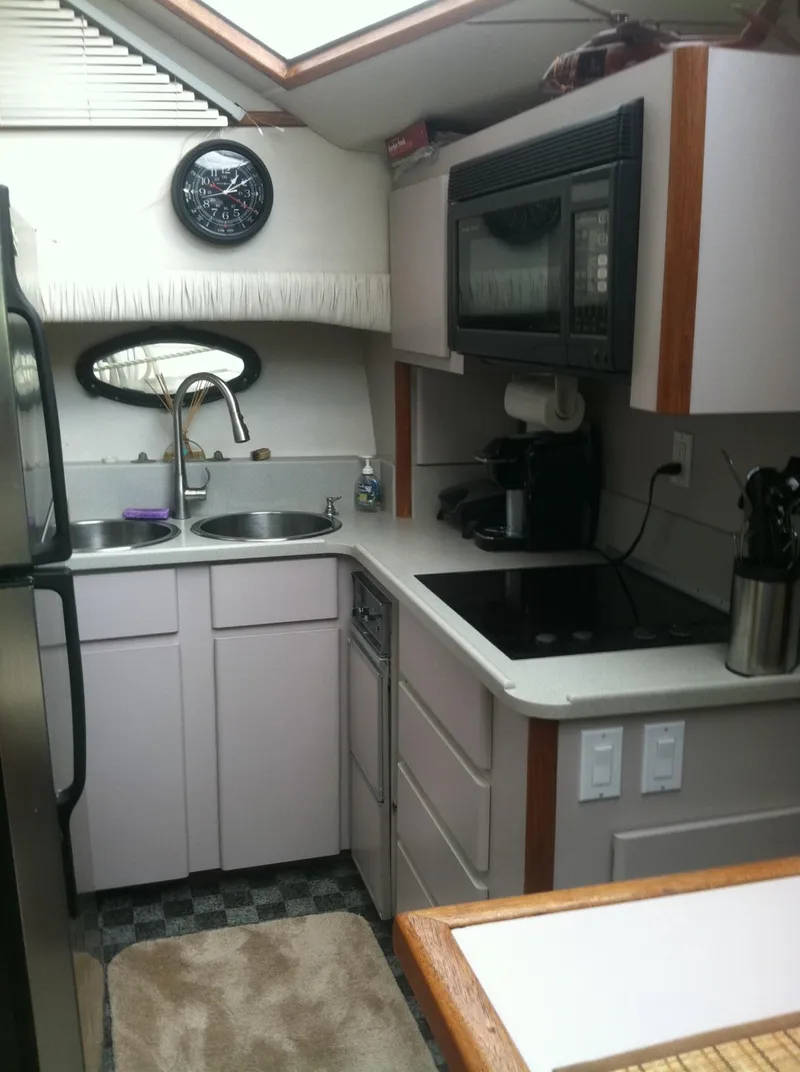 Slide: The Image of Compact kitchen in 1989 Californian 48 Motor Yacht with modern appliances and sink. - 26